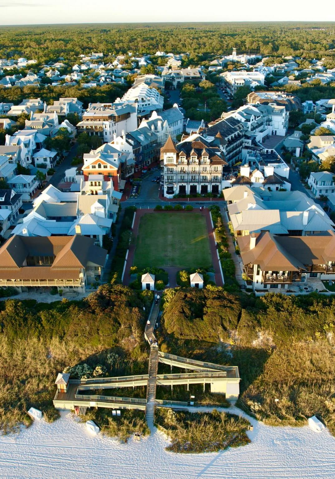 Drone photograph of upscale coastal architecture and beachfront boardwalk in Rosemary Beach, Florida